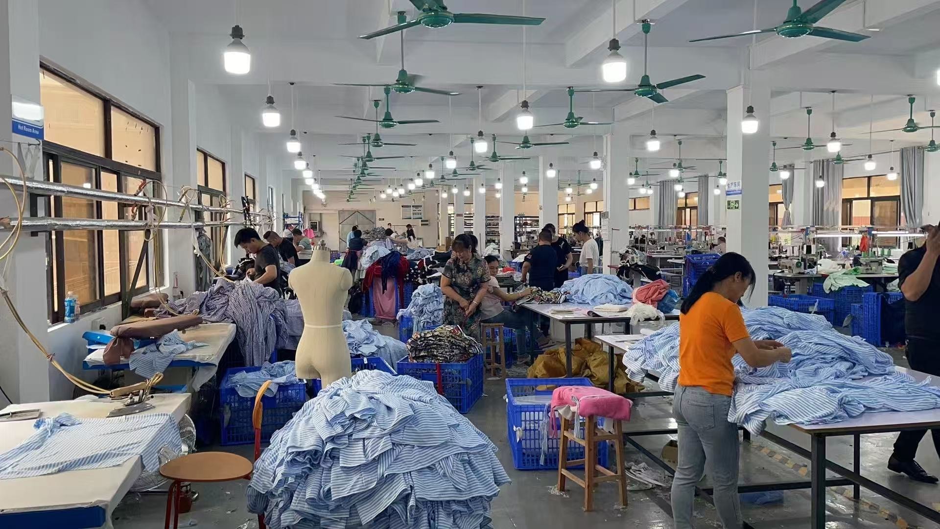 Garment production floor with team members working on woven garments